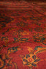 Load image into Gallery viewer, Close-up of a red patterned rug with intricate designs.