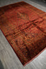 Load image into Gallery viewer, Decorative red and orange patterned rug on a wooden floor