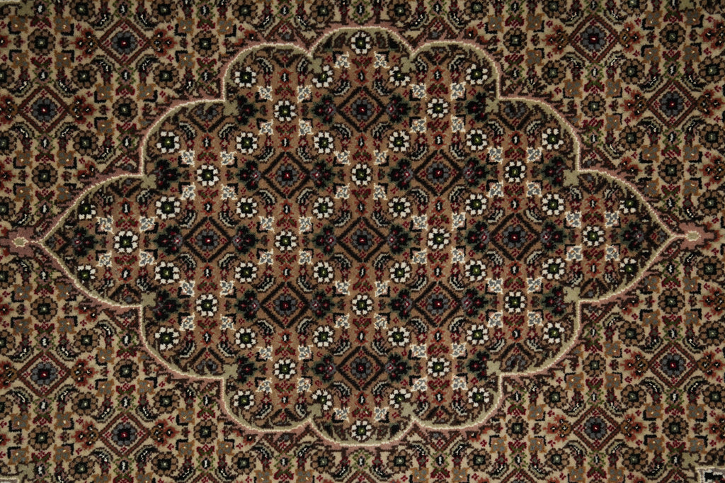 Close-up of a patterned rug with intricate designs.