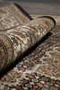 Load image into Gallery viewer, Rolling up a patterned rug with intricate designs.