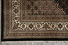 Load image into Gallery viewer, Close-up of an ornate rug with intricate patterns on a gray floor.
