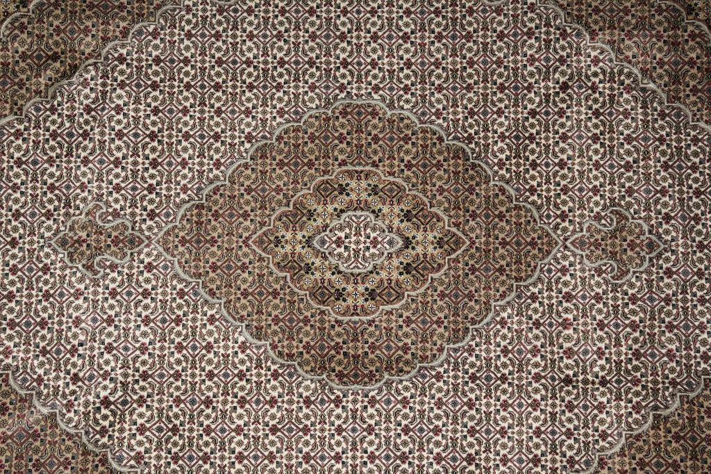 Close-up of a patterned rug with intricate designs.