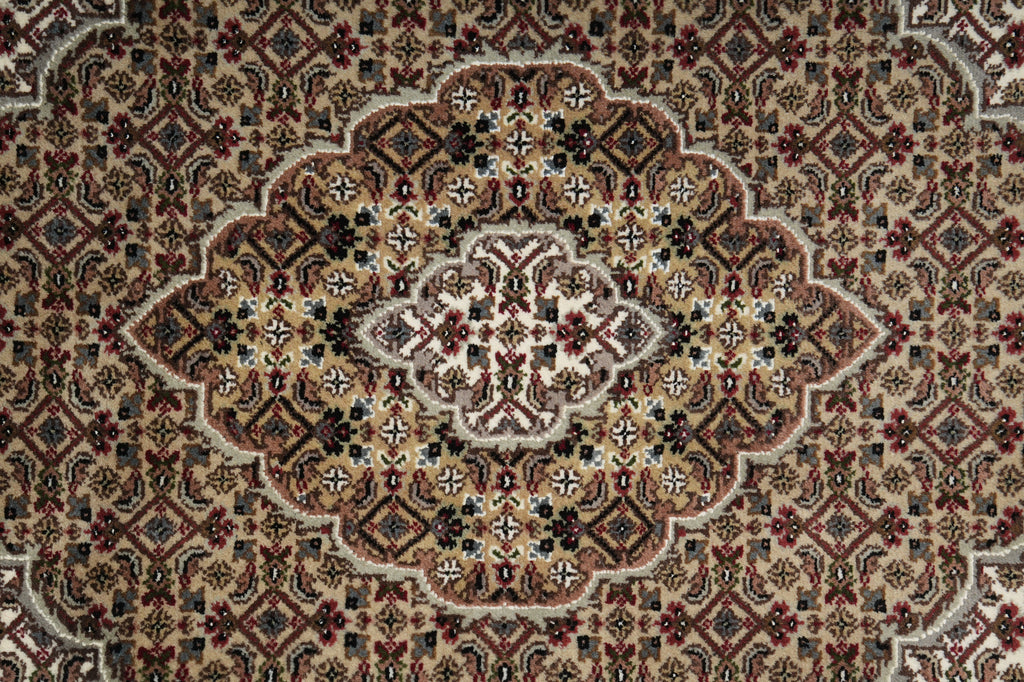 Close-up of a patterned rug with intricate designs.