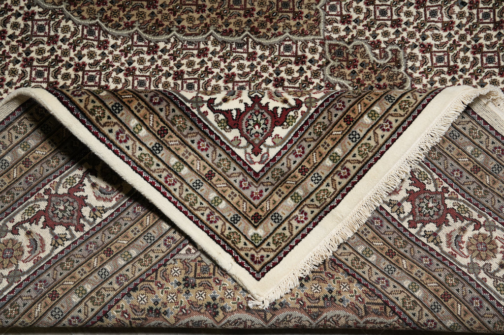 Close-up of a patterned rug with intricate designs.