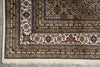 Load image into Gallery viewer, Close-up of a patterned rug with intricate designs on a gray floor.