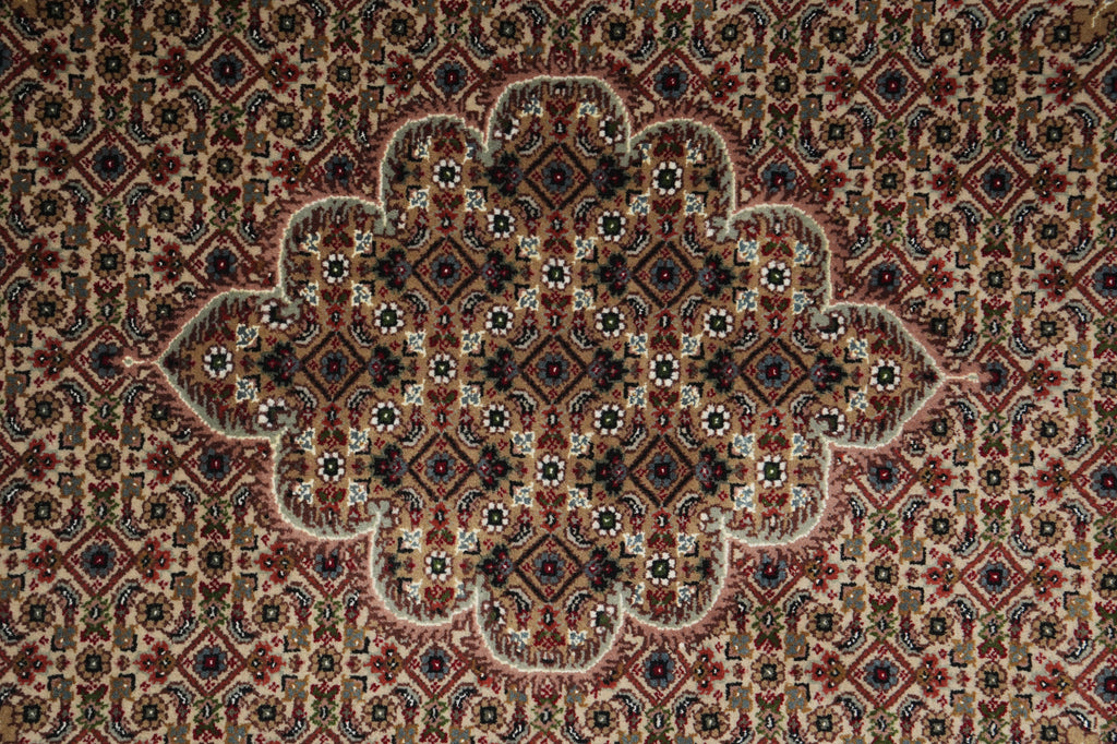 Close-up of a patterned rug with intricate designs.
