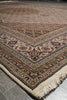 Load image into Gallery viewer, Close-up of a patterned rug with intricate designs on a tiled floor.