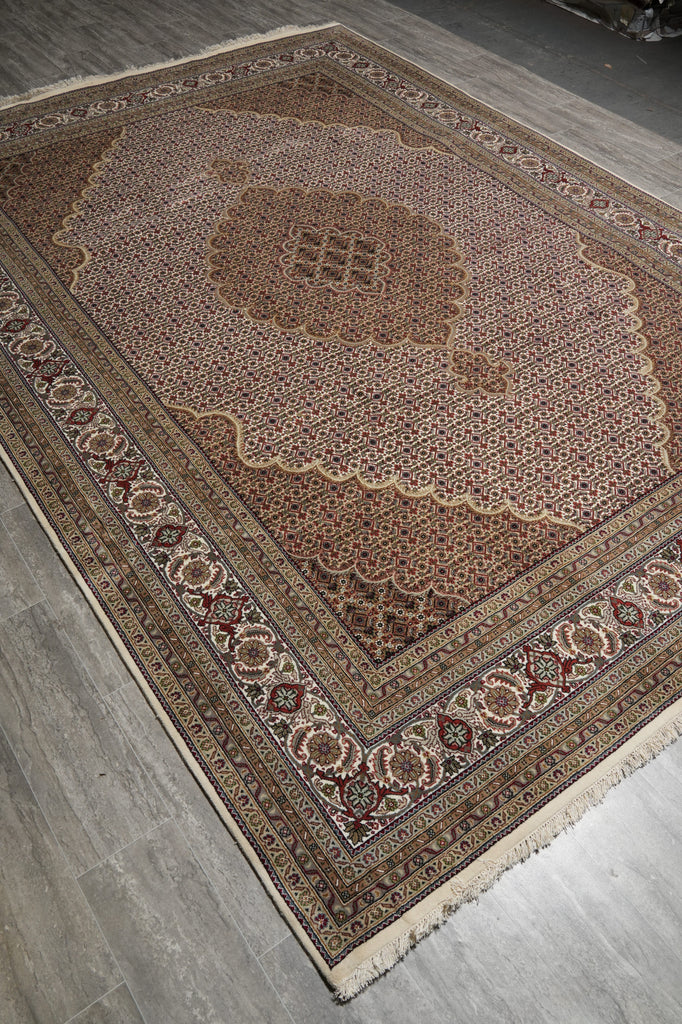 Decorative rug with intricate patterns on a wooden floor