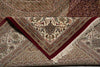 Load image into Gallery viewer, Close-up of a patterned rug with intricate designs and a red border.