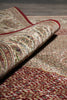 Load image into Gallery viewer, Rolling out a patterned rug with intricate designs on a wooden floor.