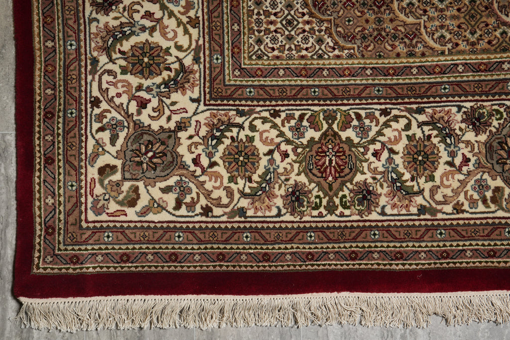 Decorative rug with intricate patterns on a gray floor