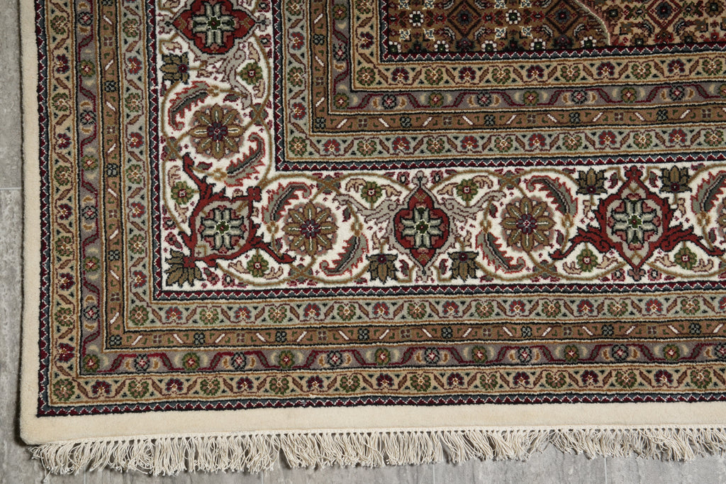 Close-up of a patterned rug with intricate designs on a neutral background
