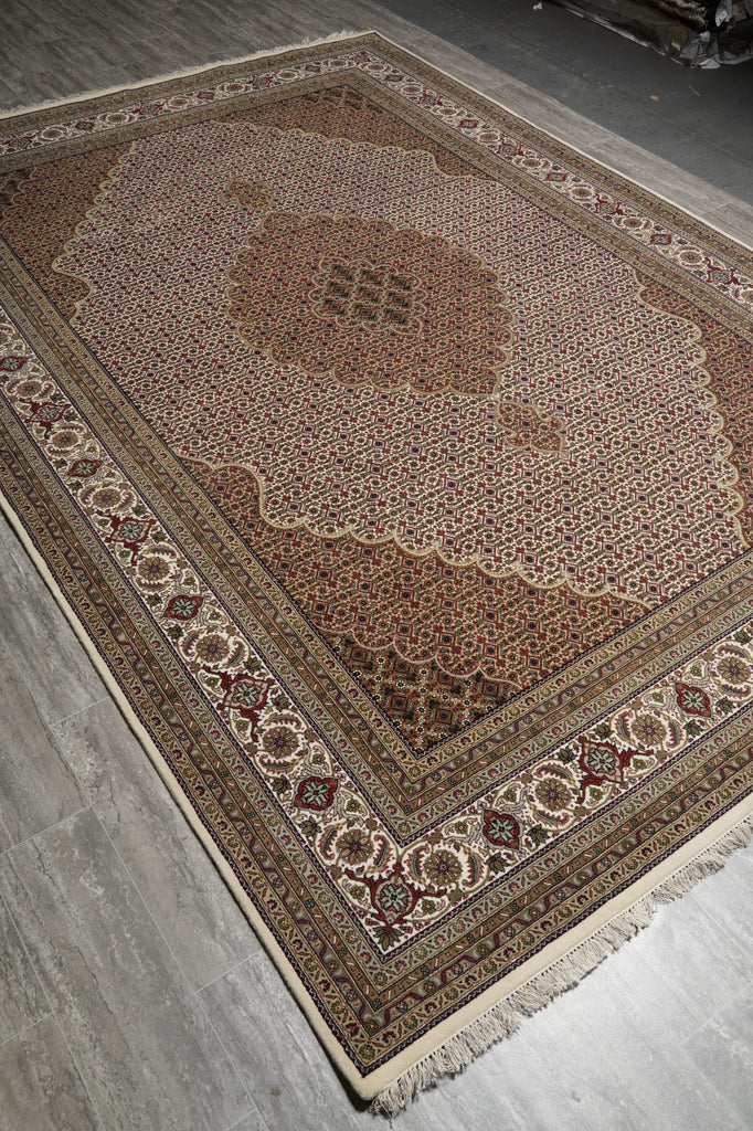 Decorative rug with intricate patterns on a concrete floor