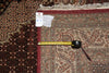 Load image into Gallery viewer, Measuring tape on a patterned rug with a visible size tag.