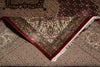 Load image into Gallery viewer, Close-up of a patterned rug with intricate designs and a red border.