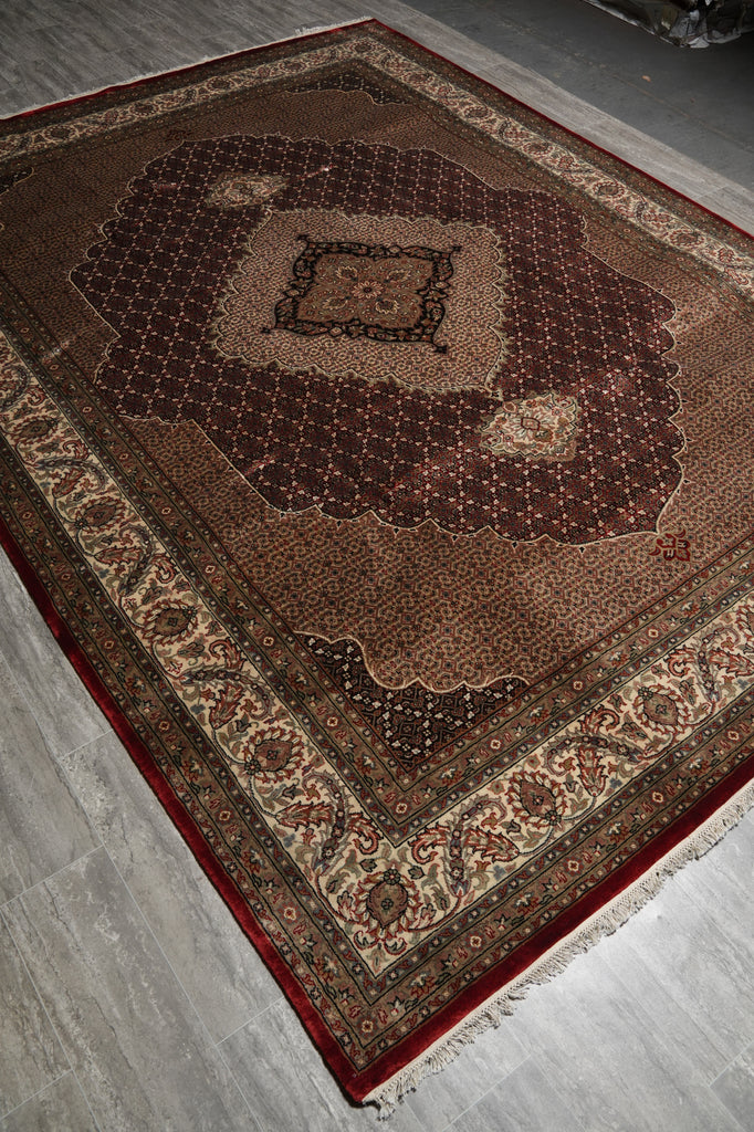 Decorative rug with intricate patterns on a wooden floor