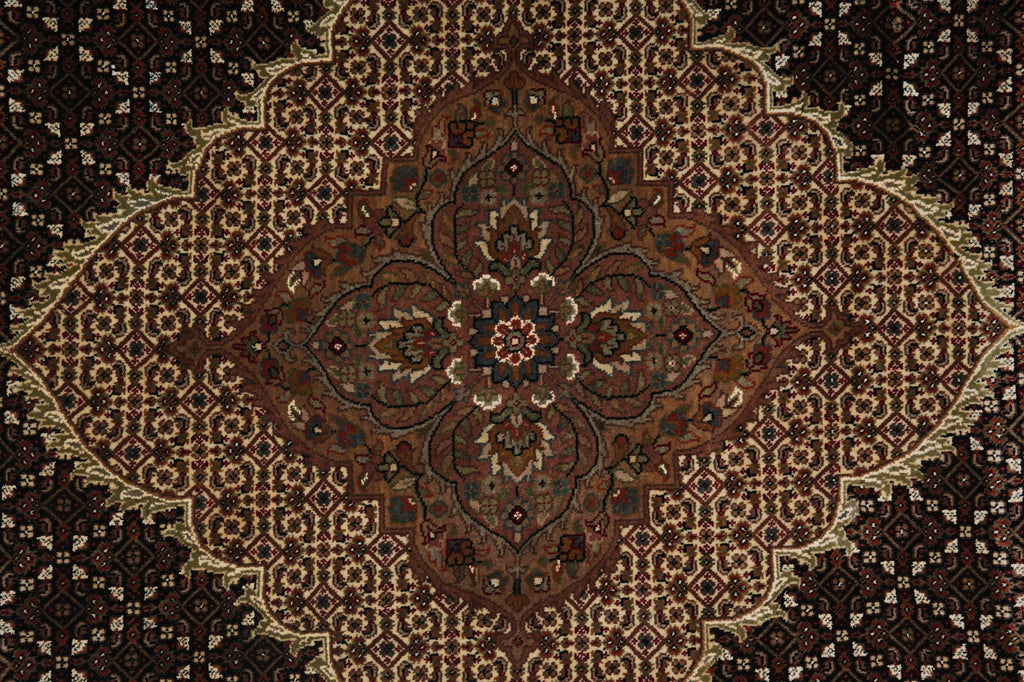 Close-up of a patterned rug with intricate designs.