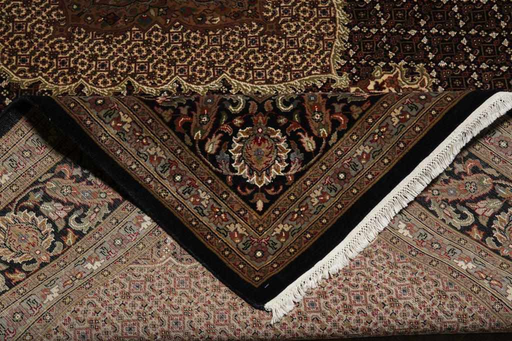 Close-up of intricately designed patterned rugs with a focus on texture and color.