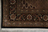 Load image into Gallery viewer, Close-up of a patterned rug with intricate designs on a gray floor.