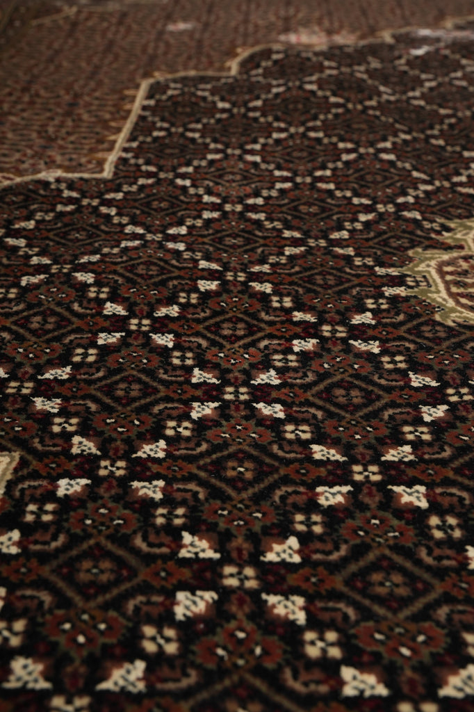 Close-up of a patterned rug with intricate designs.