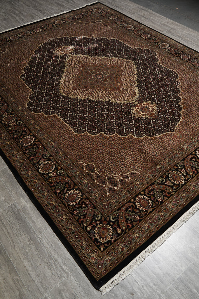 Decorative brown rug with intricate patterns on a wooden floor.
