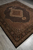 Load image into Gallery viewer, Decorative brown rug with intricate patterns on a wooden floor.