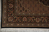 Load image into Gallery viewer, Close-up of a patterned rug with intricate designs on a gray floor.