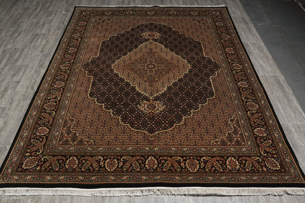 Decorative brown rug with intricate patterns on a wooden floor.