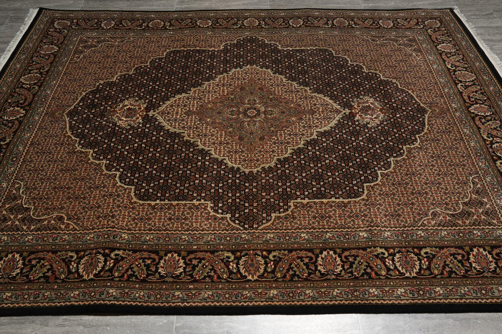 Decorative rug with intricate patterns on a wooden floor