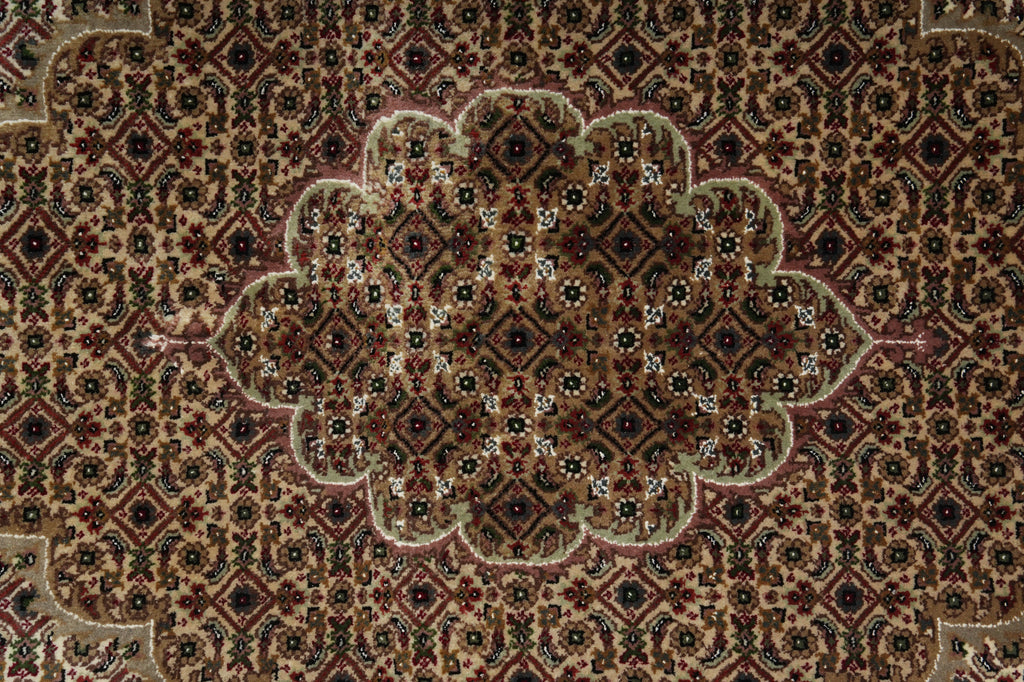 Close-up of a patterned rug with intricate designs.