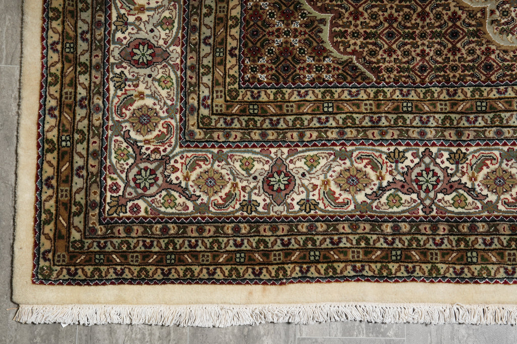 Close-up of a patterned rug with intricate designs on a neutral background