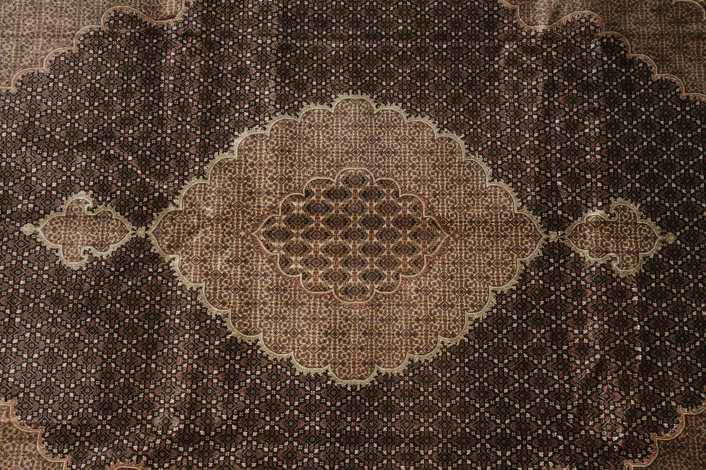 Close-up of a patterned brown rug with intricate designs.