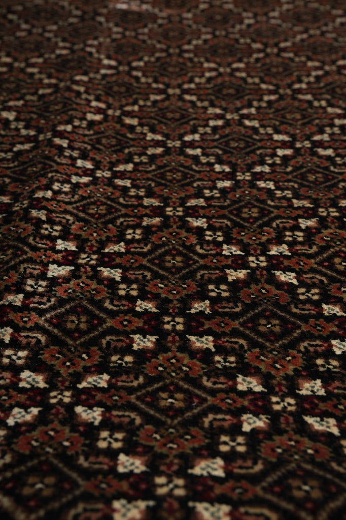 Close-up of a patterned rug with brown and beige colors