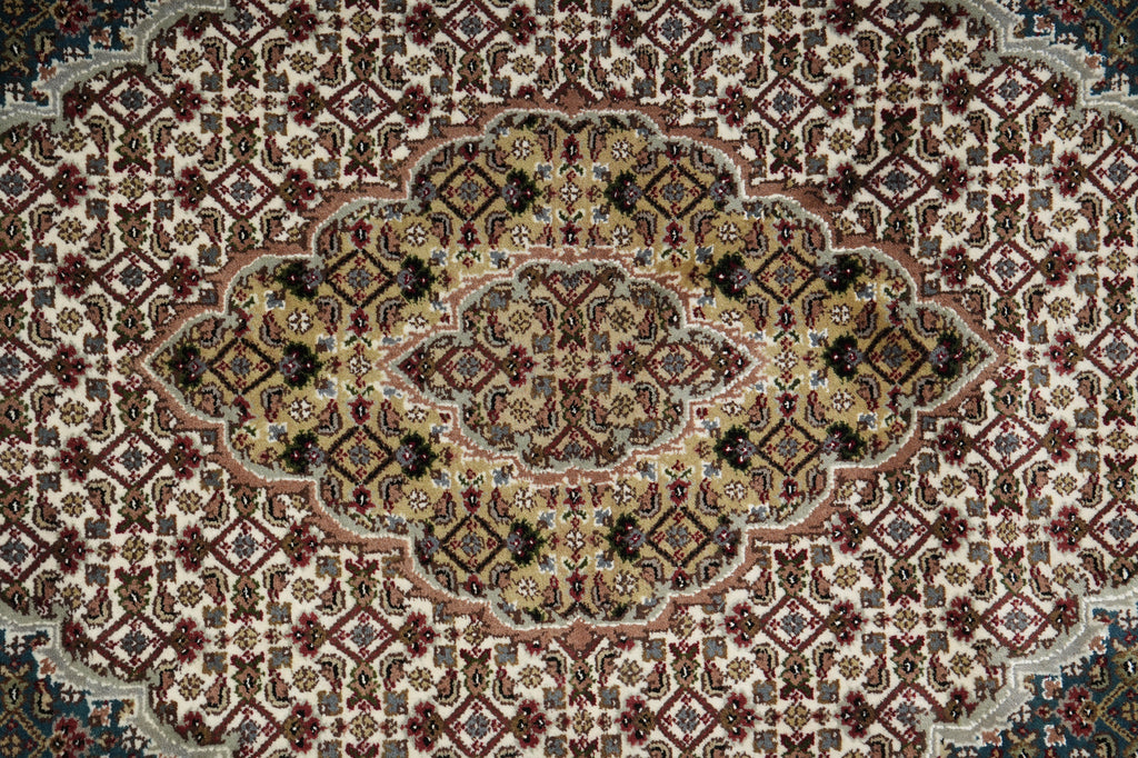 Close-up of a patterned rug with intricate designs.