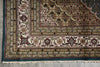 Load image into Gallery viewer, Close-up of a patterned rug with intricate designs on a concrete floor.