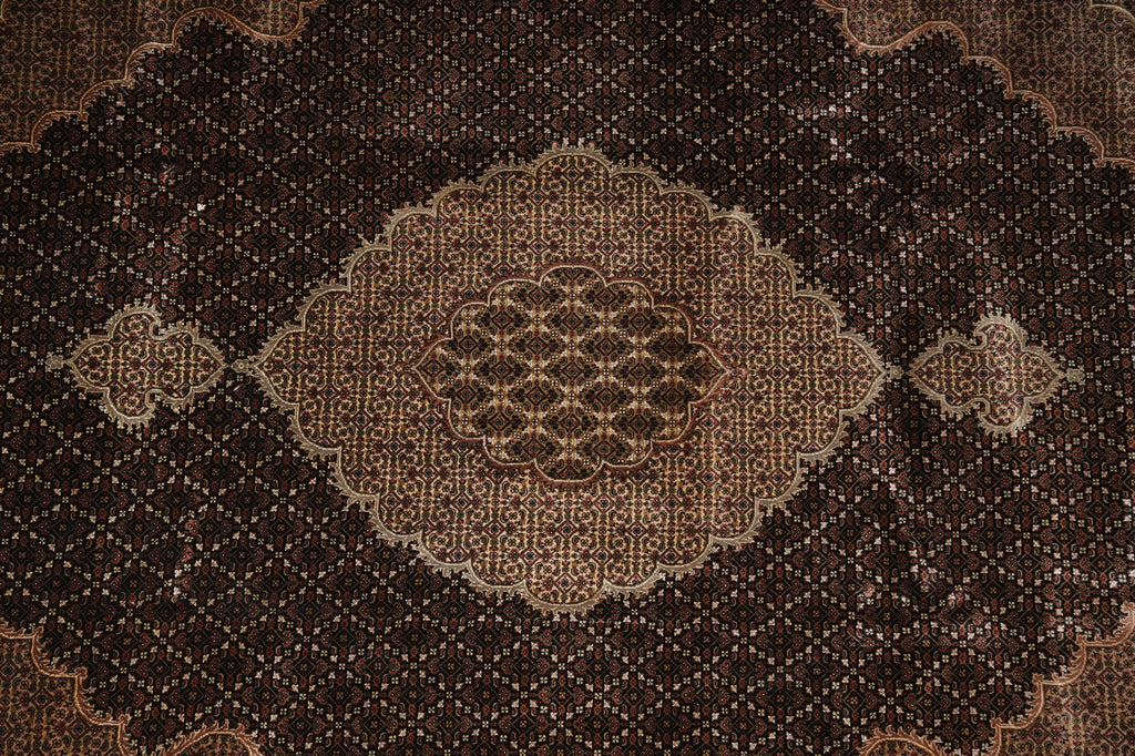 Close-up of a patterned brown rug with intricate designs.