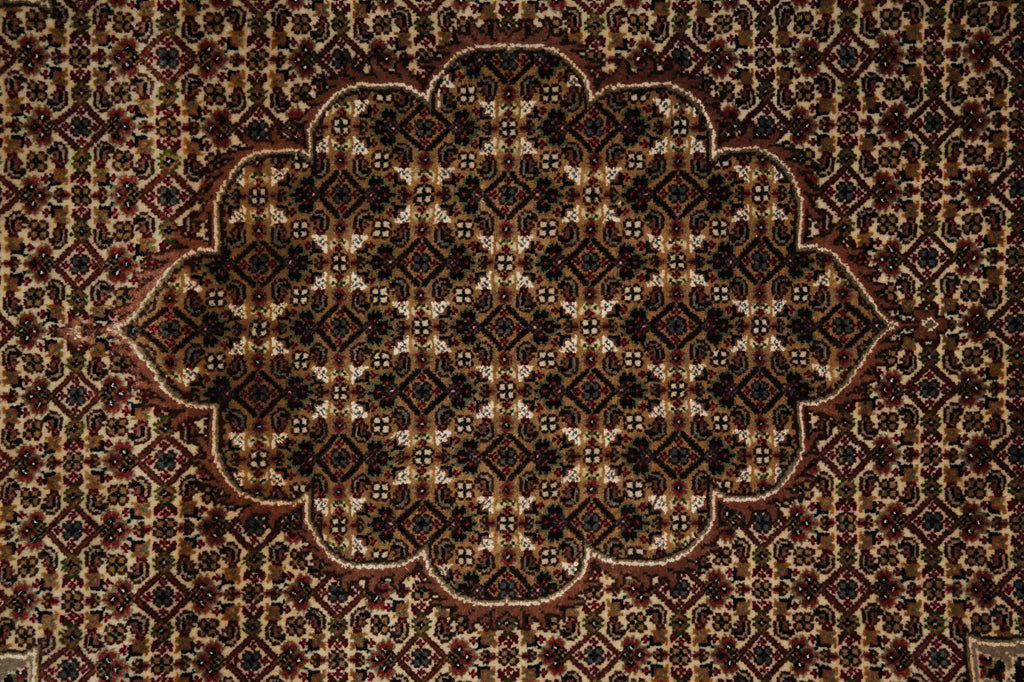 Close-up of a patterned rug with intricate designs.