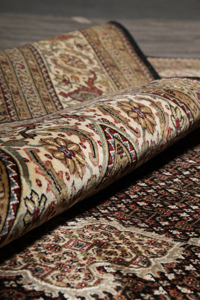 Close-up of patterned rugs with intricate designs on a plain background