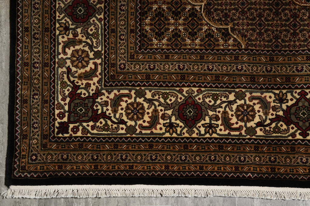 Close-up of a patterned rug with intricate designs on a neutral background