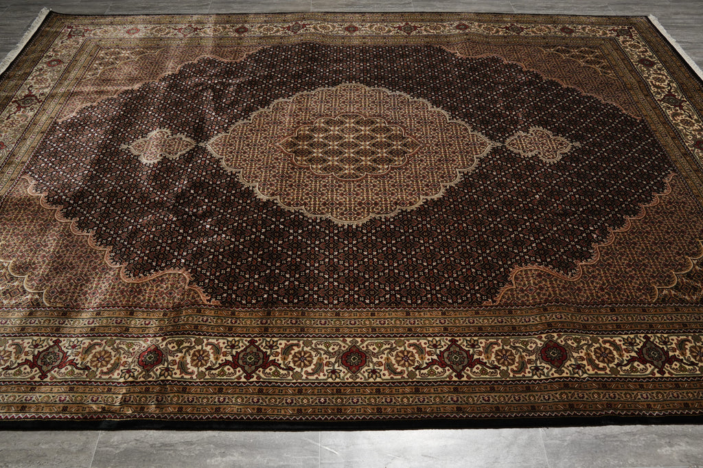 Decorative brown rug with intricate patterns on a gray floor.