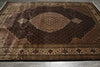 Load image into Gallery viewer, Decorative brown rug with intricate patterns on a gray floor.