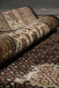 Load image into Gallery viewer, Roll of patterned fabric with intricate designs on a plain background