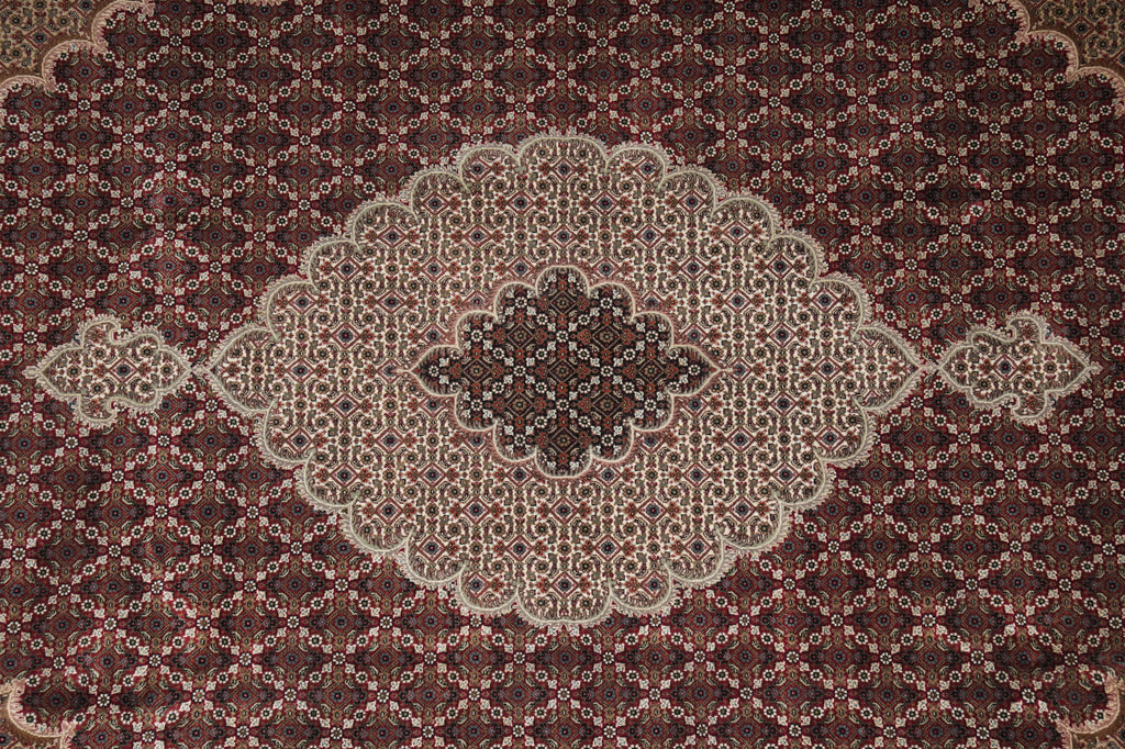 Close-up of a patterned rug with intricate designs on a brown background