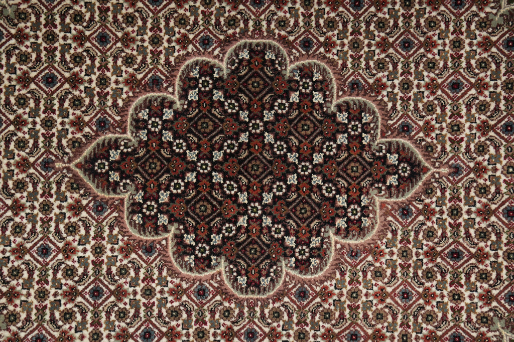 Close-up of a patterned rug with intricate designs.