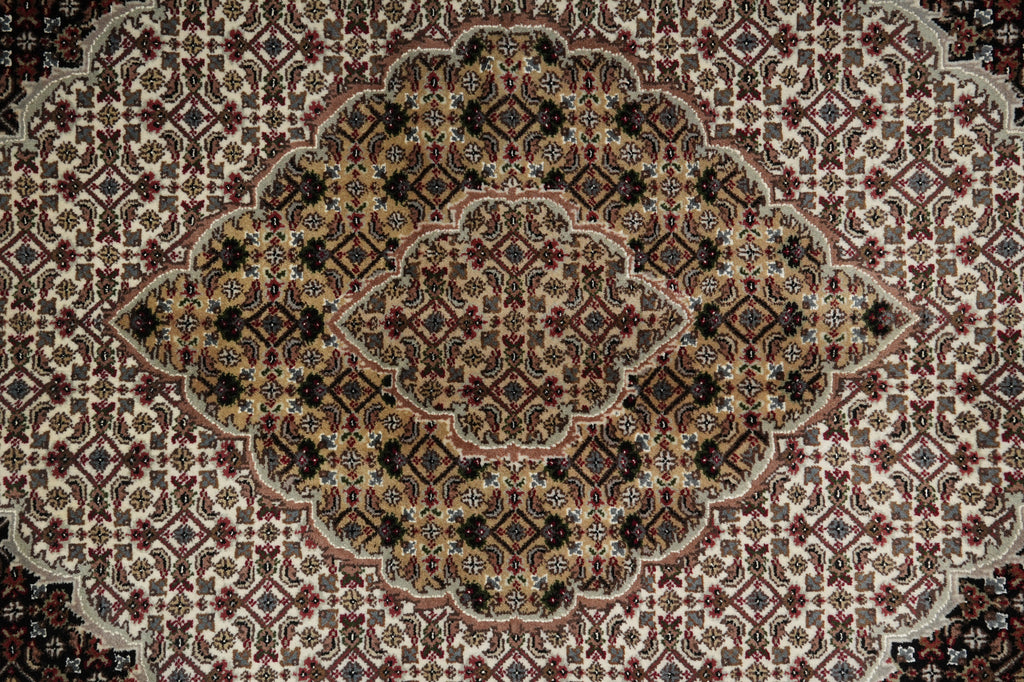 Close-up of a patterned rug with intricate designs.