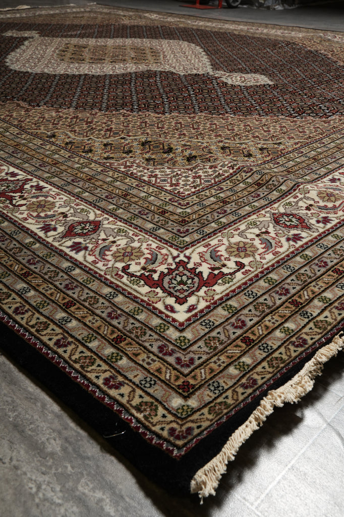 Detailed view of a patterned rug on a floor.