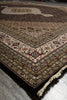 Load image into Gallery viewer, Detailed view of a patterned rug on a floor.