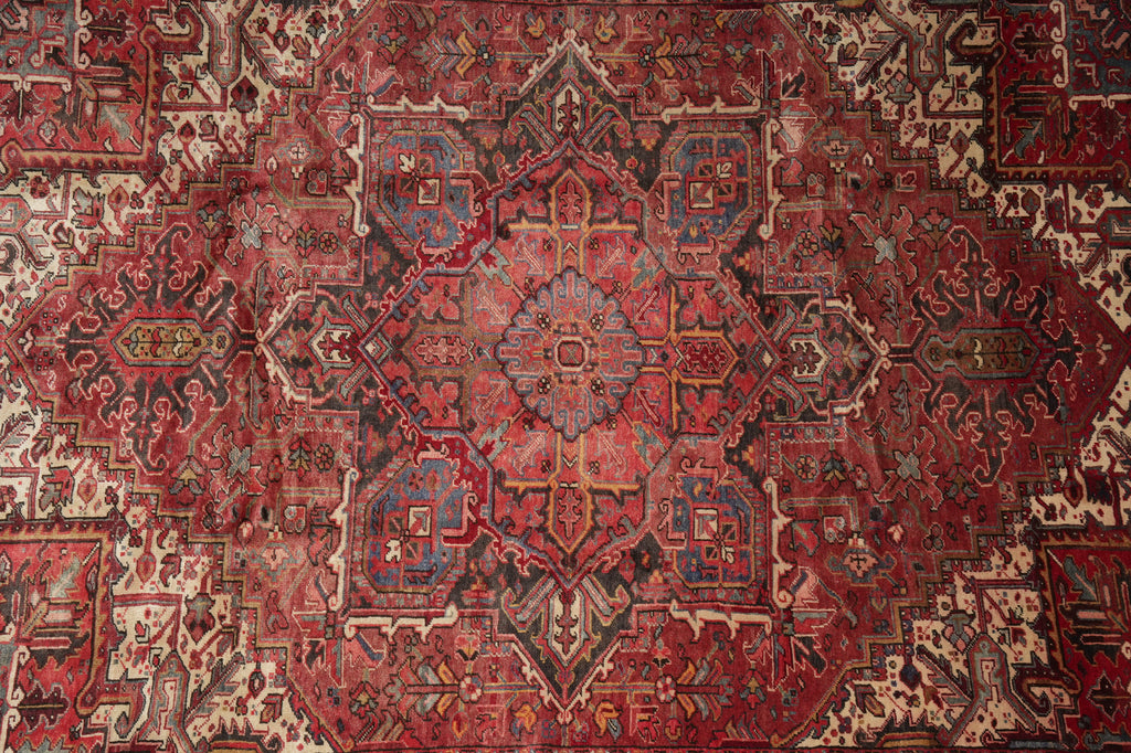 Close-up of a red and brown patterned rug with intricate designs.