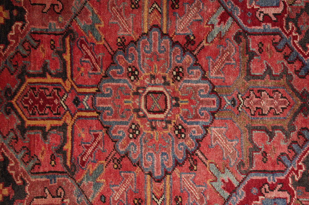 Close-up of a red patterned rug with intricate designs