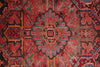 Load image into Gallery viewer, Close-up of a red patterned rug with intricate designs